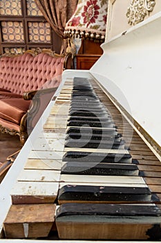 Vintage retro room setting with sofa, accessories, old rusty white piano. Ideal for postcard