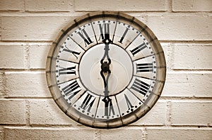 Vintage retro style clock on a white brick wall
