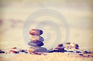 Vintage retro style image of stones on beach