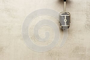 Vintage retro style silver microphone, top view, copy space