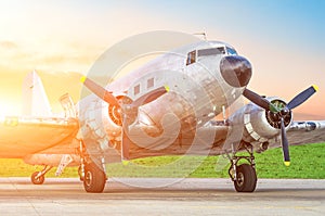 Vintage retro turboprop airplane, with engines on the wings, in the evening at sunset at the airport