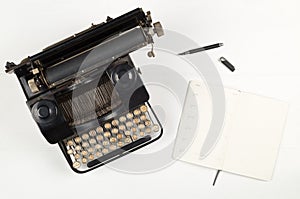 Vintage retro typewriter and open notebook with pen on white wooden table background top view flat lay from above - journalism or