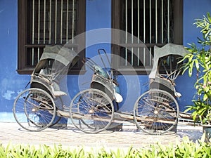 Vintage Rickshaw outside of the Blue Mansion located in Georgetown, Malaysia