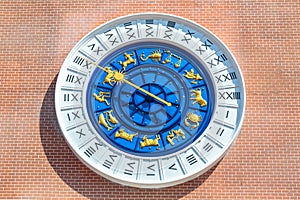 Vintage roman zodiac clock on the red brick wall.