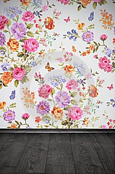Vintage room with floral colorful wallpaper and wooden floor