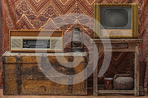 Vintage room with old radio, antique vintage lamp and retro tv over obsolete wallpaper