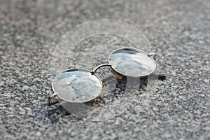 Vintage round glasses on granite background