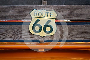 Vintage route 66 road sign  on wooden planks of pickup truck -
