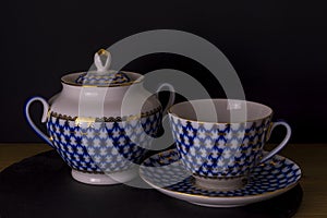 Vintage Russian porcelain teacup and sugar-bowl, isolated black background, Russian style cup