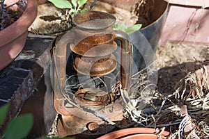 Vintage rust and brocken kerosene lamp on backyard