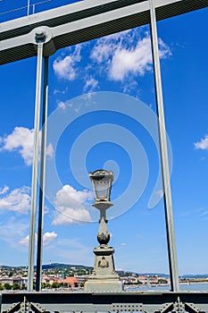 Vintage rusted lighting pole with clear blue sky in the background on SzÃÂ©chenyi Chain Bridge over Danube in Budapest, Hungary