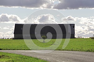 Vintage rustic old barn in a green field