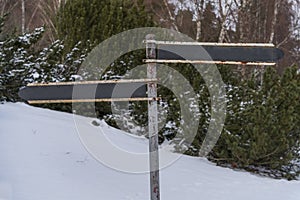 Vintage rusty blank directional sign in winter