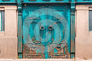 Vintage rusty Entrance door undar platform decorated with wrought iron.