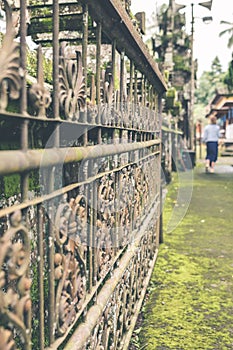 VIntage Rusty Fence in the balinese temple, tropical island of Bali, Indonesia. Hindu temple. Ancient fence.