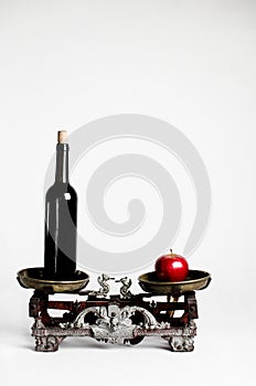 Vintage scale on white background with alcohol and apple