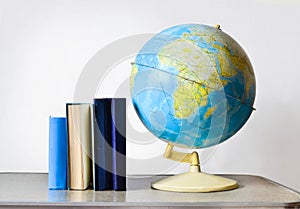Vintage school globe and books on the table