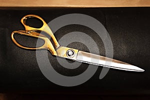 Vintage scissors on the background of leather