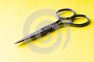 vintage scissors on a yellow background macro