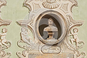 Vintage sculpture portrait of Francesco Petrarca on a facade of an old building in Bellinzona, Switzerland photo