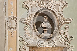 Vintage sculpture portrait of Galileo Galilei on a facade of an old building in Bellinzona, Switzerland