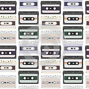 Vintage seamless pattern with analogue music cassettes. 80s Loopable background with magnetic audio tapes