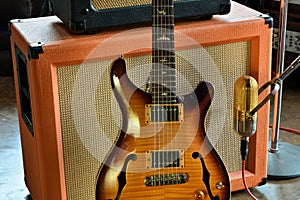 Vintage Semi Hollowbody Electric Guitar with Tube Amplifier and Ribbon Microphone Studio Stock Photo