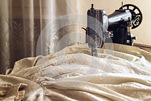 Vintage sewing machine with an old bride dress