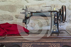Vintage sewing machine and red fabric