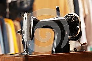 Vintage sewing machine with thread in workshop, closeup