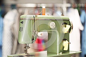 Vintage sewing machine with thread in workshop, closeup