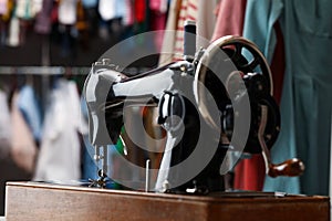 Vintage sewing machine with thread in workshop, closeup