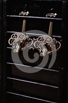 vintage shabby bronze hooks on a dark background in a vintage interior