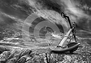 Vintage ship anchor on a sea beach