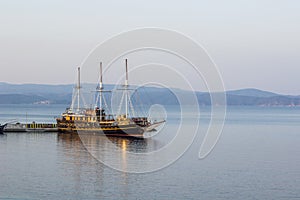 Vintage ship in dock ocean bay calm waters scenic nautical view , copy space for your text here