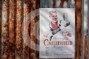Vintage sigarette poster advertising Chesterfield mounted on rusty corrugated iron