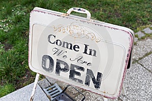 Vintage sign board with text word `Come in we are Open`