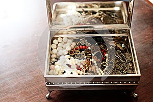 Shiny trinkets in silver box photo