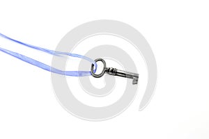 Vintage silver key on blue ribbon on white background