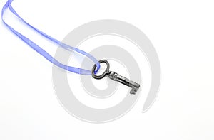 Vintage silver key on blue ribbon on white background