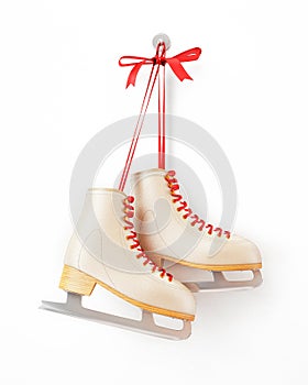 Vintage skates hanging on the white wall, isolated on white background