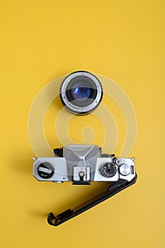 A vintage SLR camera with chrome body, lens detached.