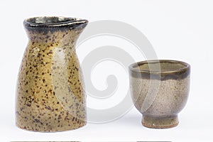 Vintage small Sake Pitcher and Cup on isolate white background.