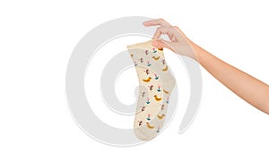 Vintage smelly holey sock object in hand. Woman holding sock isolated on white background and texture. The warm bright socks with