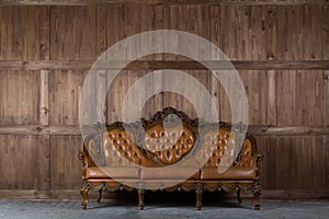 Vintage sofa near wooden wall