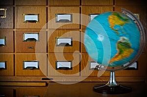 Vintage Spinning Globe in front of old Library Card Catalogue