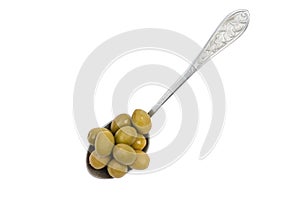 Vintage spoon with green olives isolated