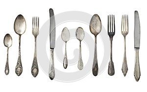 Vintage spoons, forks and knives isolated on a white background. photo