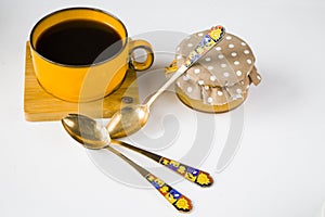 Vintage spoons, silverware, black coffee cup on the table