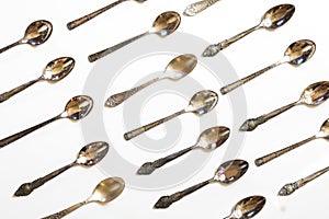 Vintage spoons, silverware pattern on white background. Kitchen texture. Top view.